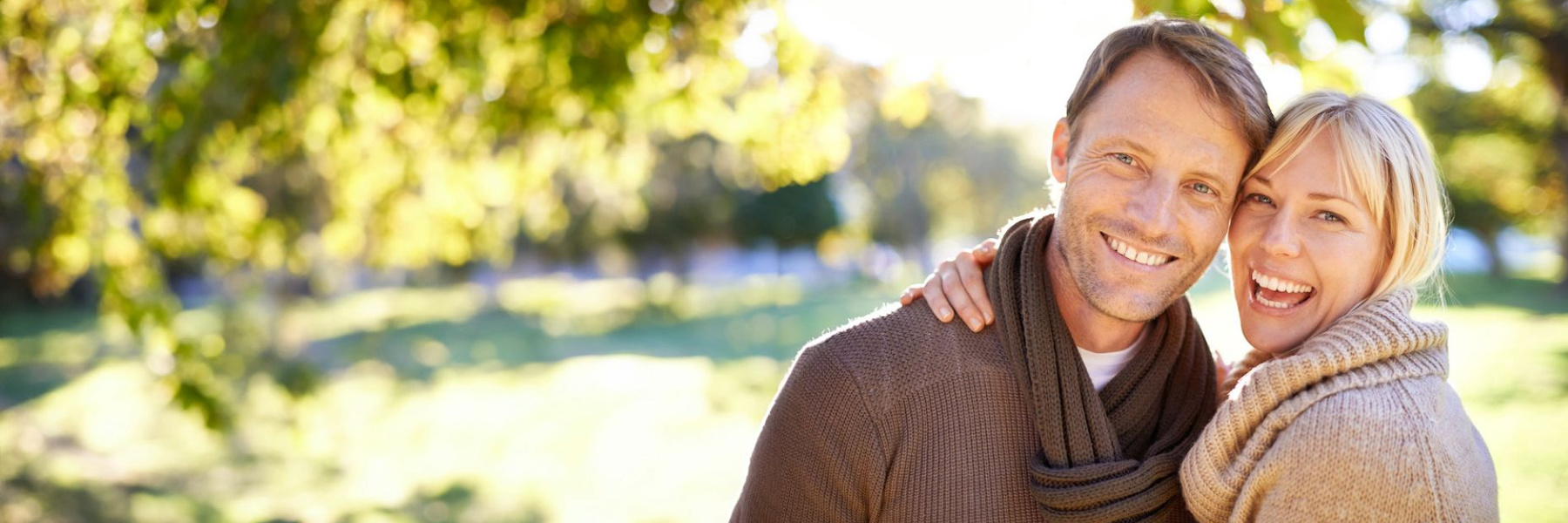 middle ages couple hugging outside | dental implants uptown houston