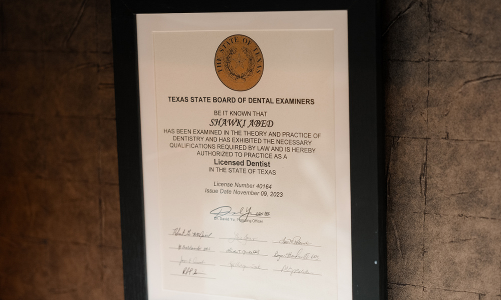 Framed Texas State Board of Dental Examiners license for Dr. Shawki Abed displayed on office wall